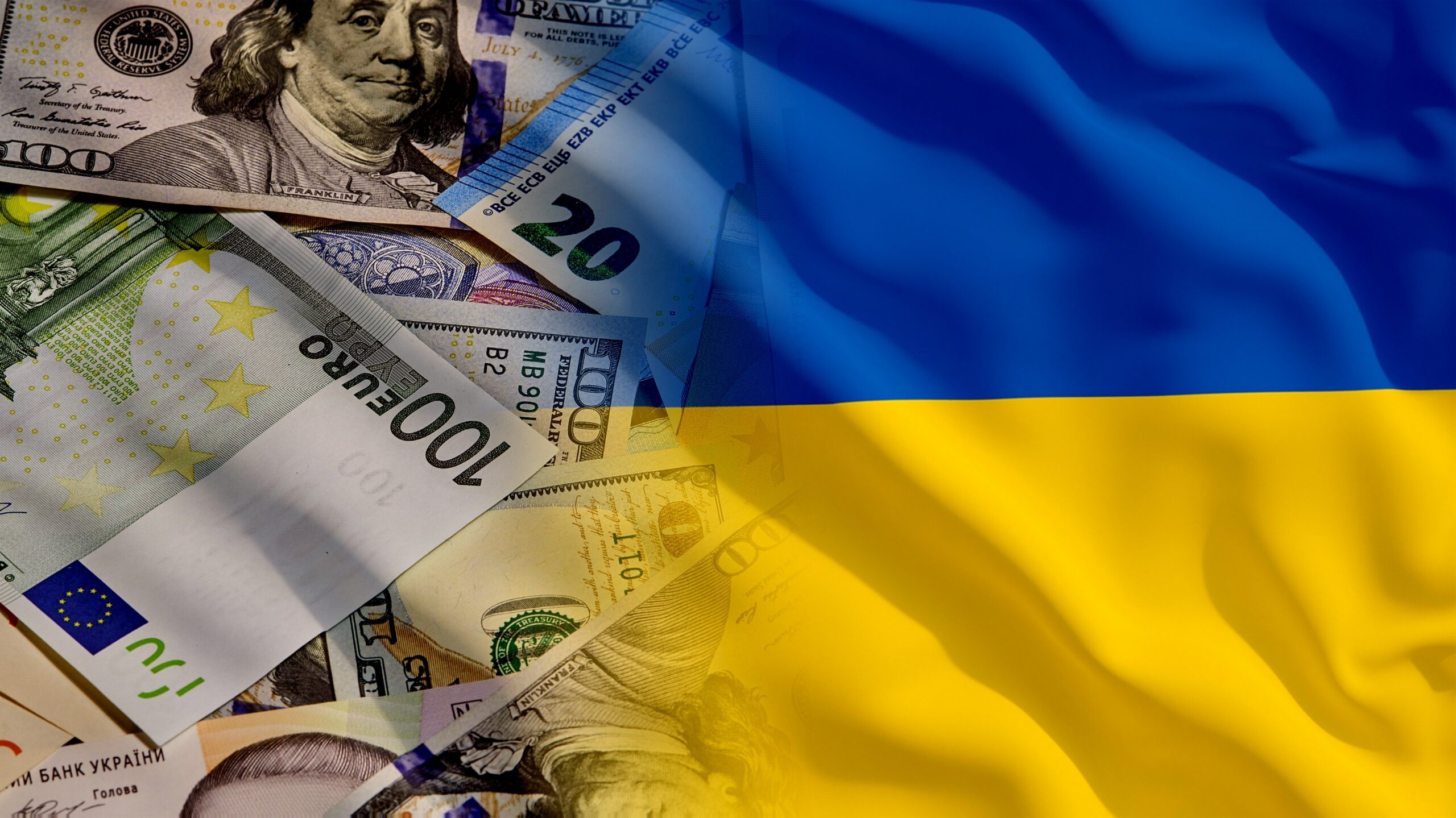 Composition of international banknotes with the Ukrainian flag on top, as a visual reference to currency, economy and financial context.