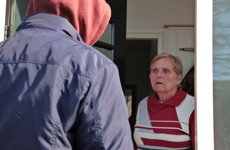 Fraudster posing as a bank employee visits an older person at home