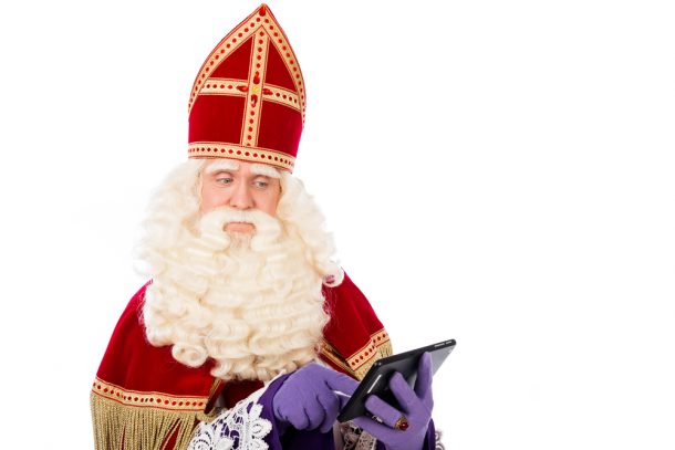 Sinterklaas taps on a tablet against a white background.